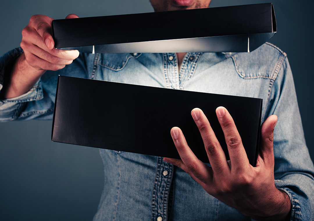 picture of someone opening a box that appears to have a light glowing inside