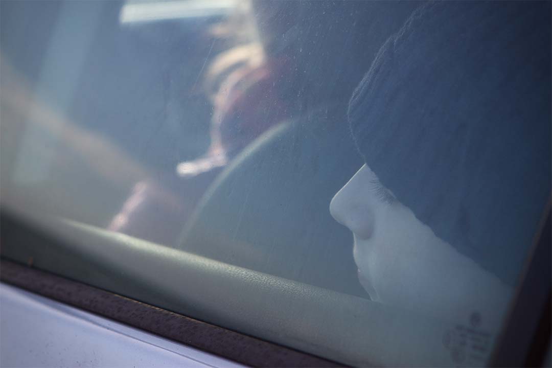 Boy in the back seat of a car on a long journey