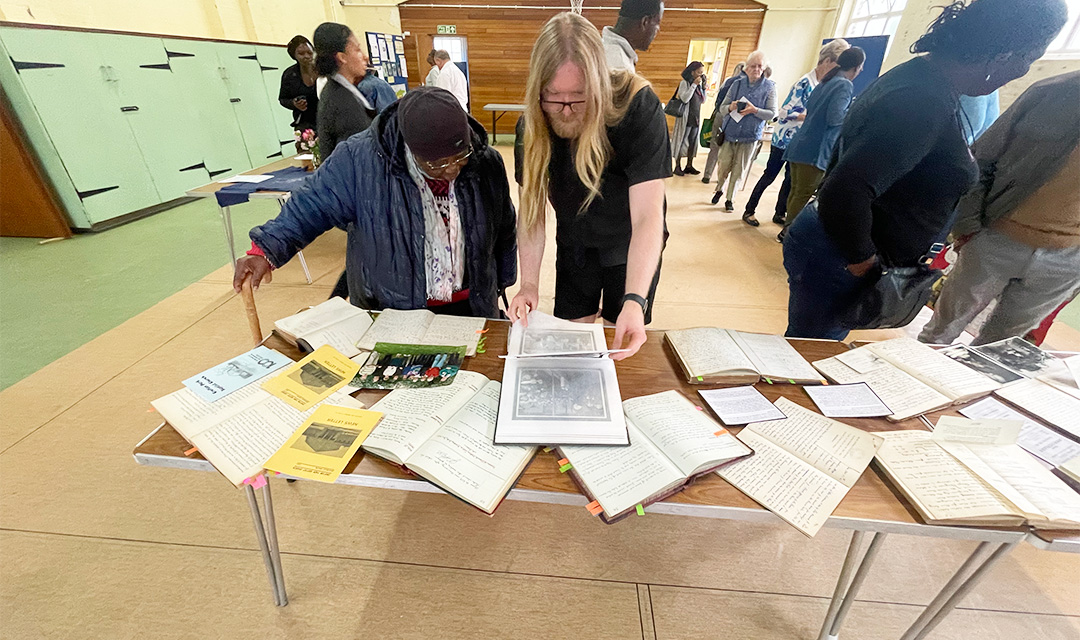Church members looking at historical documents on display in the church hall