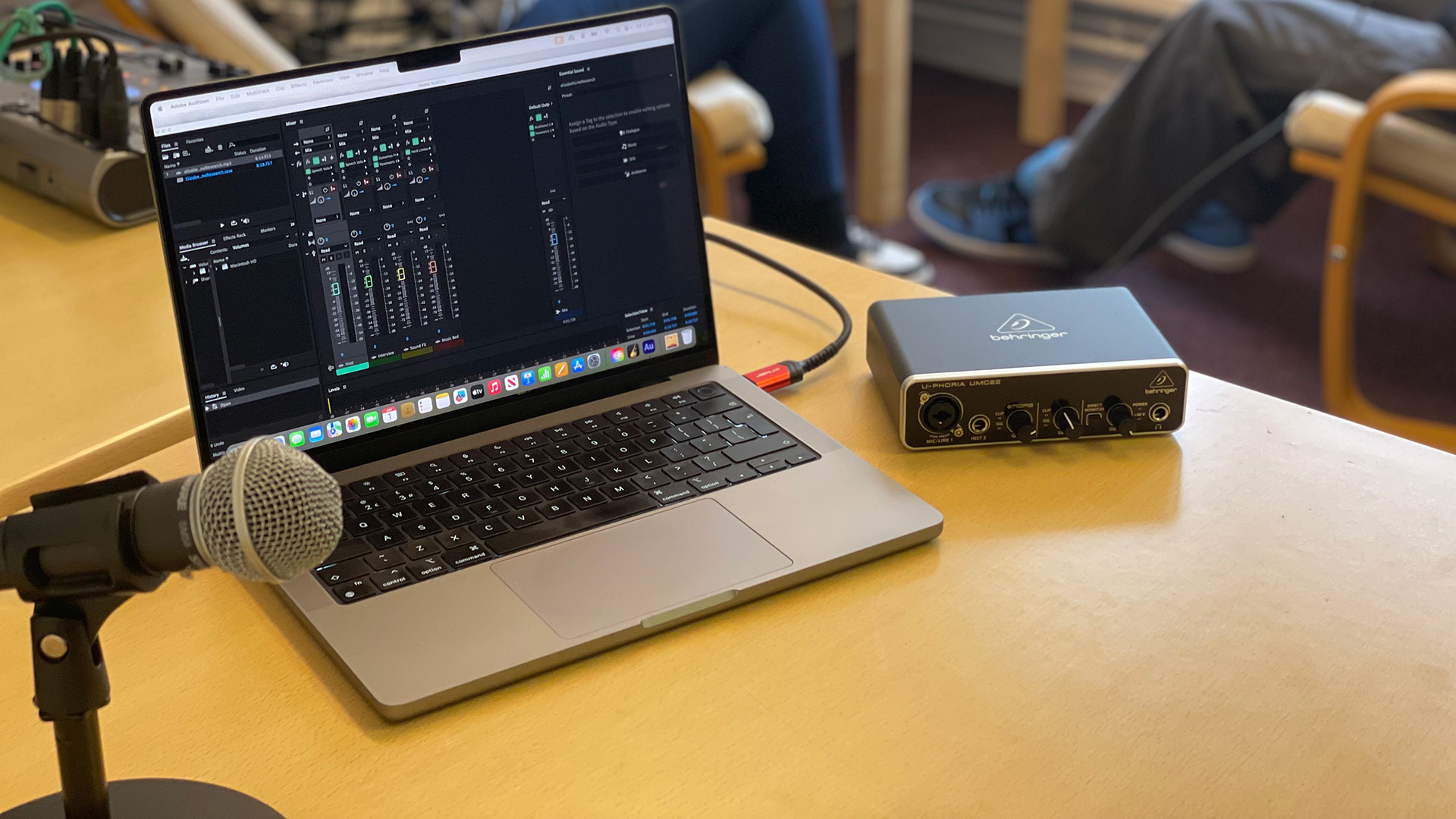 A laptop showing audio tracks in a podcast studio