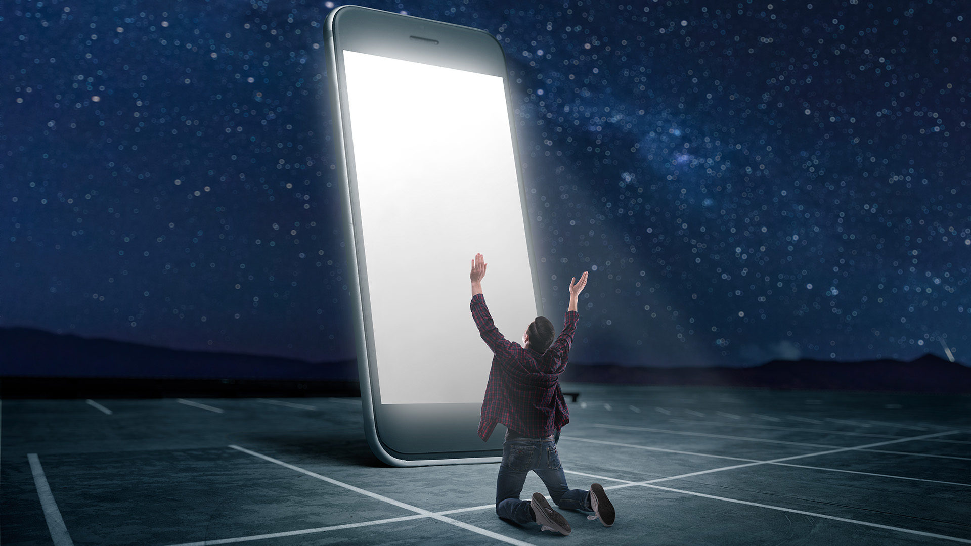 A man bows before a giant iPhone